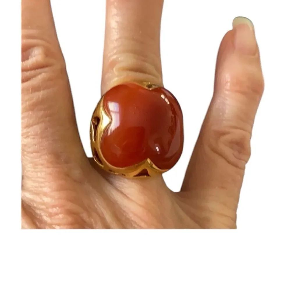 Very ornate gold colored ring with a large orangish center stone size 5 EUC